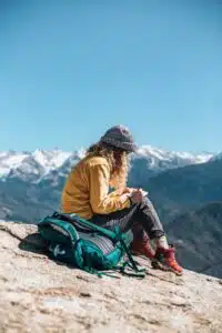 a person sitting on a mountain and journaling 