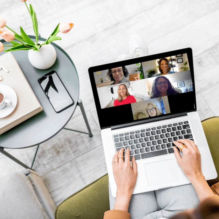 A laptop screen displaying a virtual meeting with Dr. Stephanie Grunewald and participants in the Total Life Reset program by Ancorio.