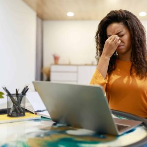 Young Black Woman Tired After Using Laptop Working On Computer